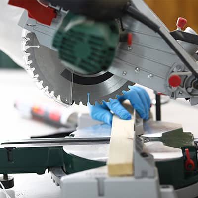 A person cutting wood with a saw