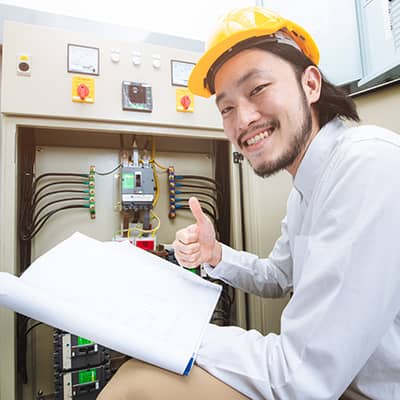 Smiling person examining a control panel