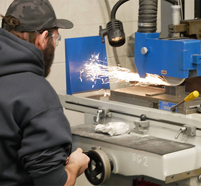 Student working on a surface grinder