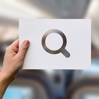 A keyboard with a microscope on the search button