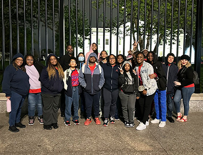 Group of happy students and teacher on a field trip