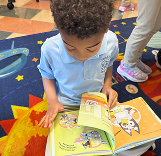Young student reading a book