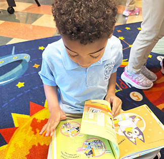 Young student reading a book