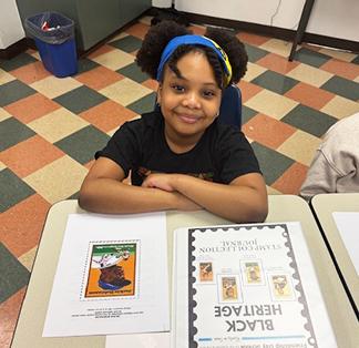 Happy student sitting at her desk