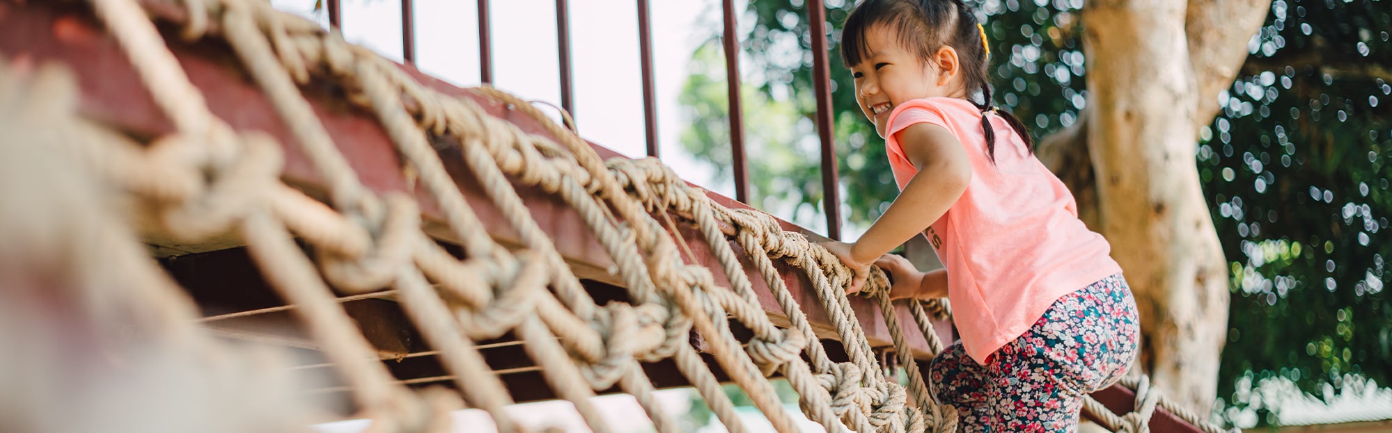 child climbing a rope ladder