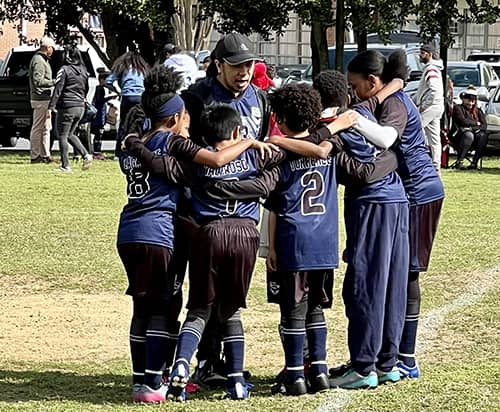 St. Mary's soccer team in a huddle during a game