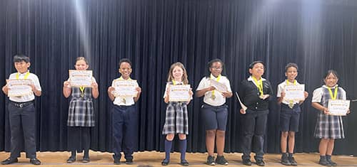Students on stage during a spelling bee
