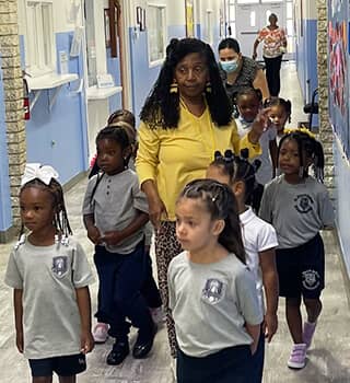 Teacher with students in the hallway