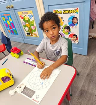 Student looking up from his desk in the classroom