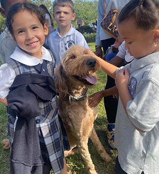 Smiling students with dog