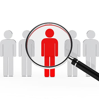 five people icons with a magnify glass hovering over one