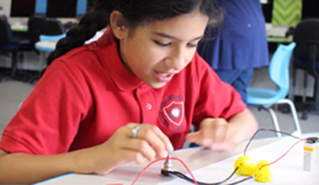 Student completes a project using wires