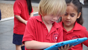 Students use tablets outside