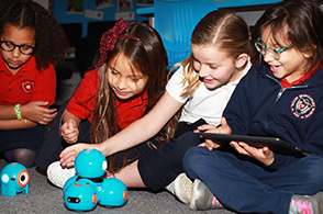 Female students use laptops in class