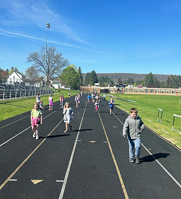 Young students walking around the school track