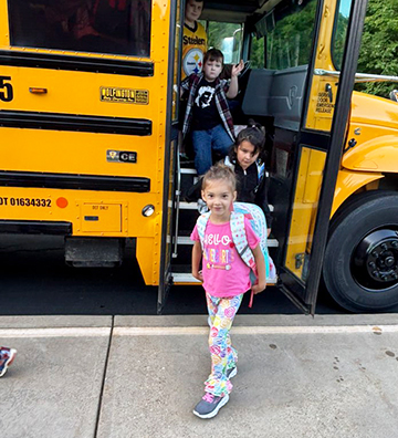 Student getting off of a school bus