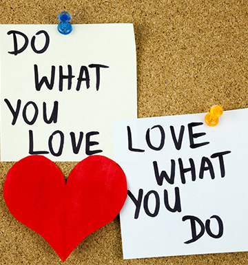 A person holding a sapling in their hands