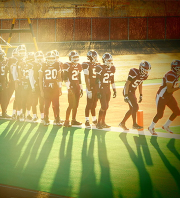 Football players walking onto the field