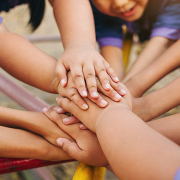 Kids putting their hands together