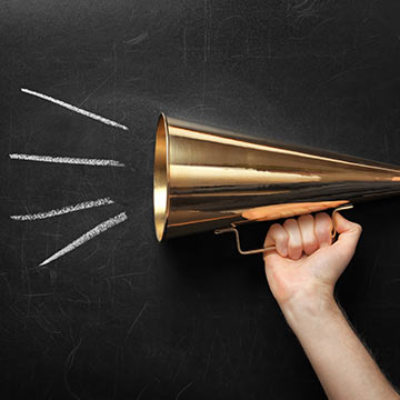 Megaphone by a chalkboard