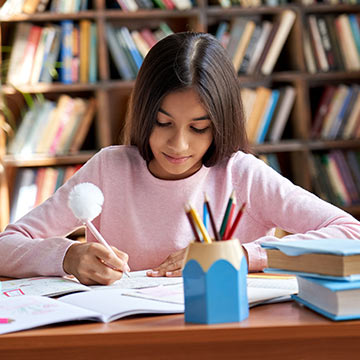 Girl working on assignments in the library