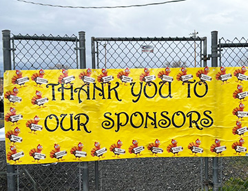 Thank you to our sponsors on a yellow banner on the school fence