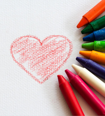 Crayons arranged around a red heart