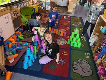Students with cup towers