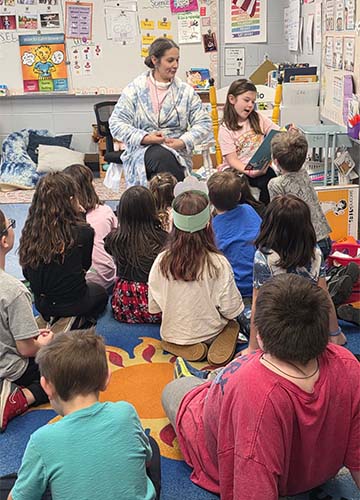Students listening to a teacher reading