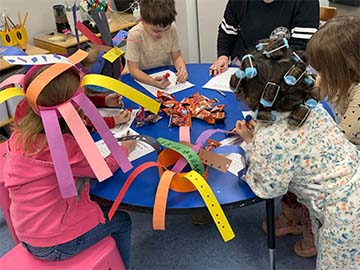 students working with silly hats