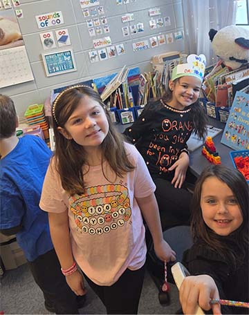three students smiling