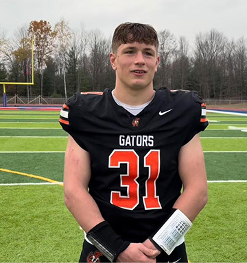Student in a Gators football uniform