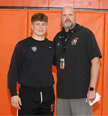 Student and Coach standing together