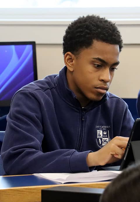 male student working hard in a classroom