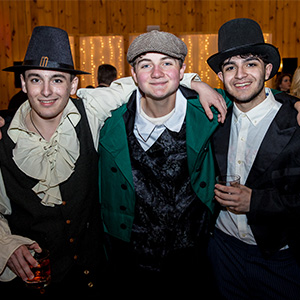 Three happy student actors wearing hats