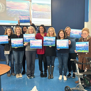 Parent Association members enjoying a night out at a paint and sip event