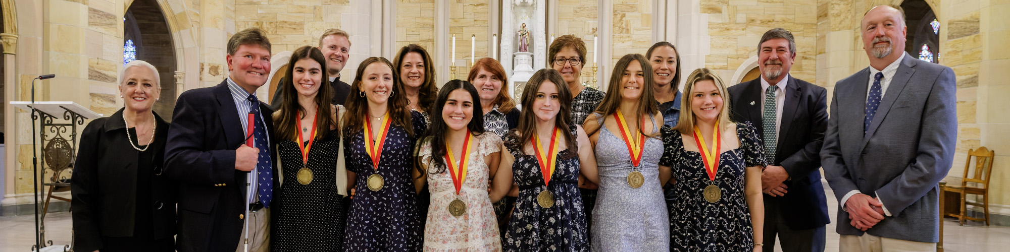 group photo of adults and students wearing award necklaces