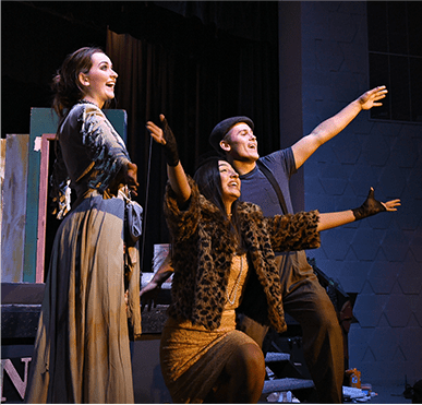 Three student actors on stage