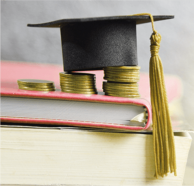 Graduation cap and coins on a book