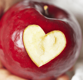 apple with a heart cut out of it