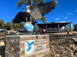Eagle sitting on a globe on a brick pedestal: 2023 Top of the Rim #4437 Eagles