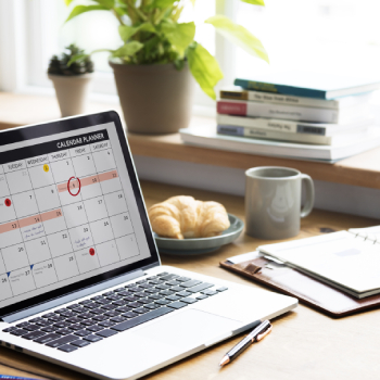 calendar on laptop screen sitting on desk