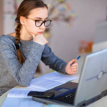 girl working on laptop at home