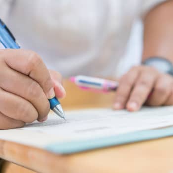 student writing in notebook