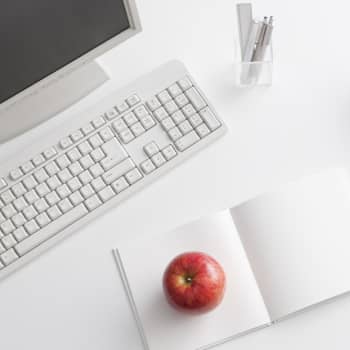 computer on desk with apple