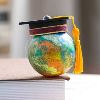 degree hat on top globe