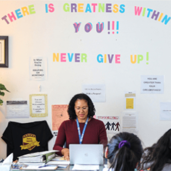 teacher sitting at her desk
