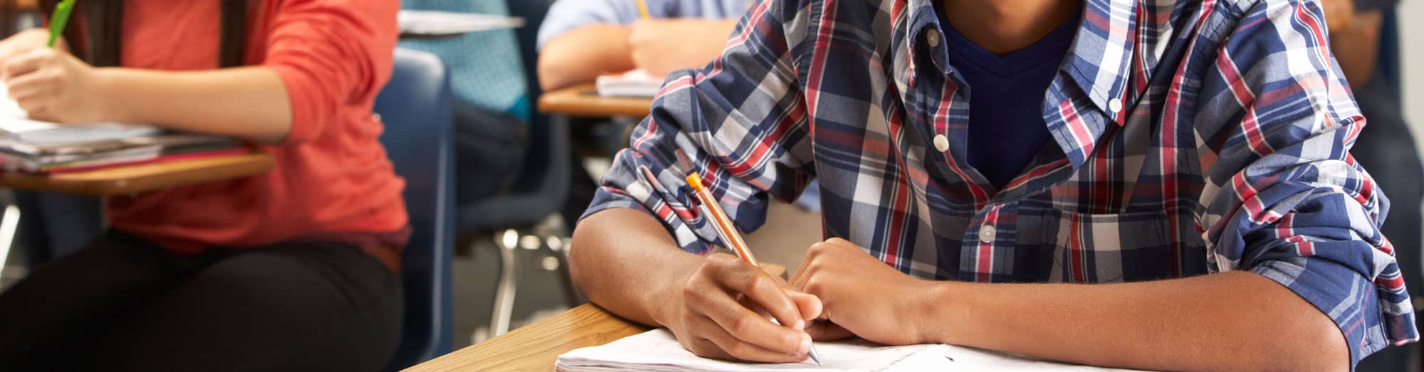 Closeup of a student writing on paper