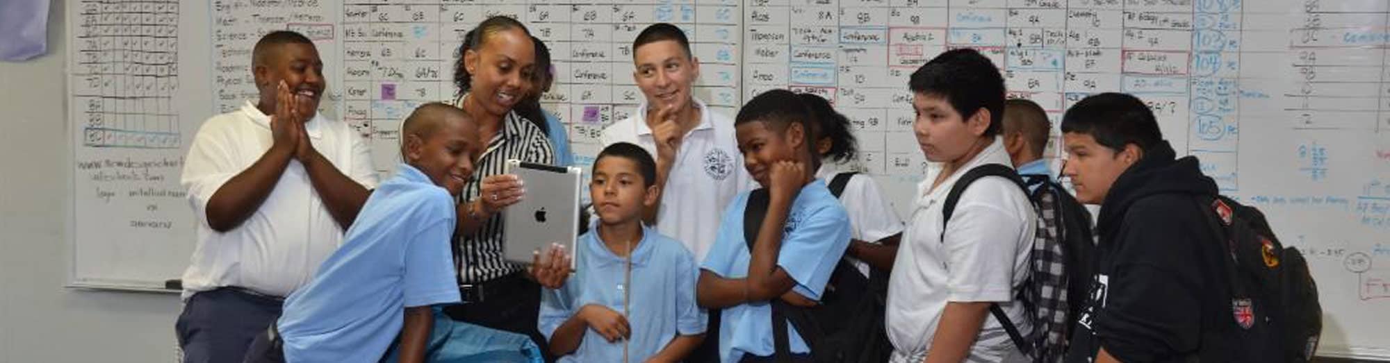 A teacher standing with a group of students