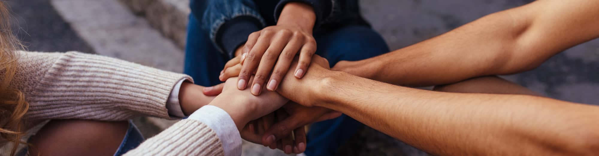 Students hands in a pile